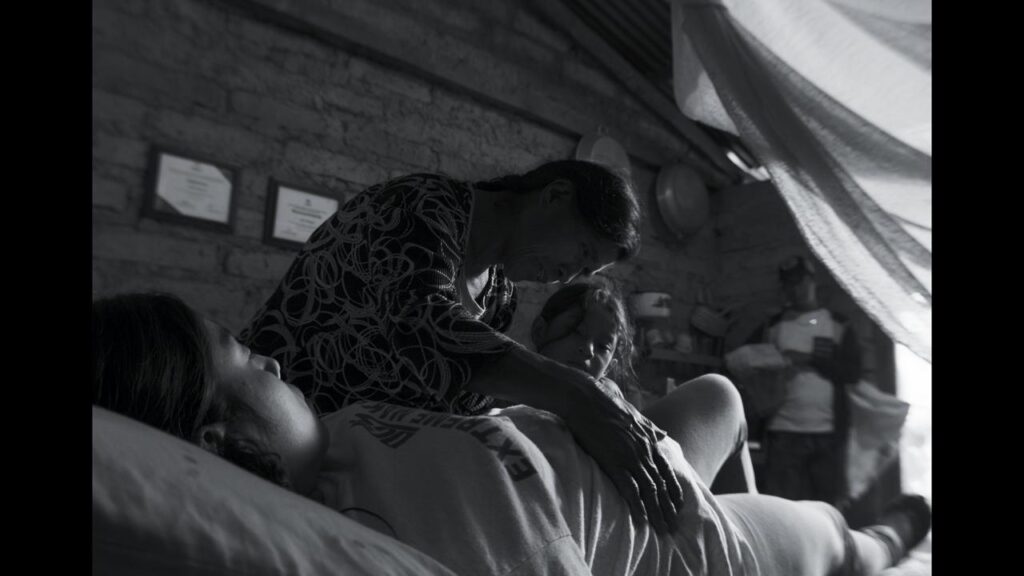 A scene from La Reserva showing a grandmother teaching a young girl about aiding a pregnancy.