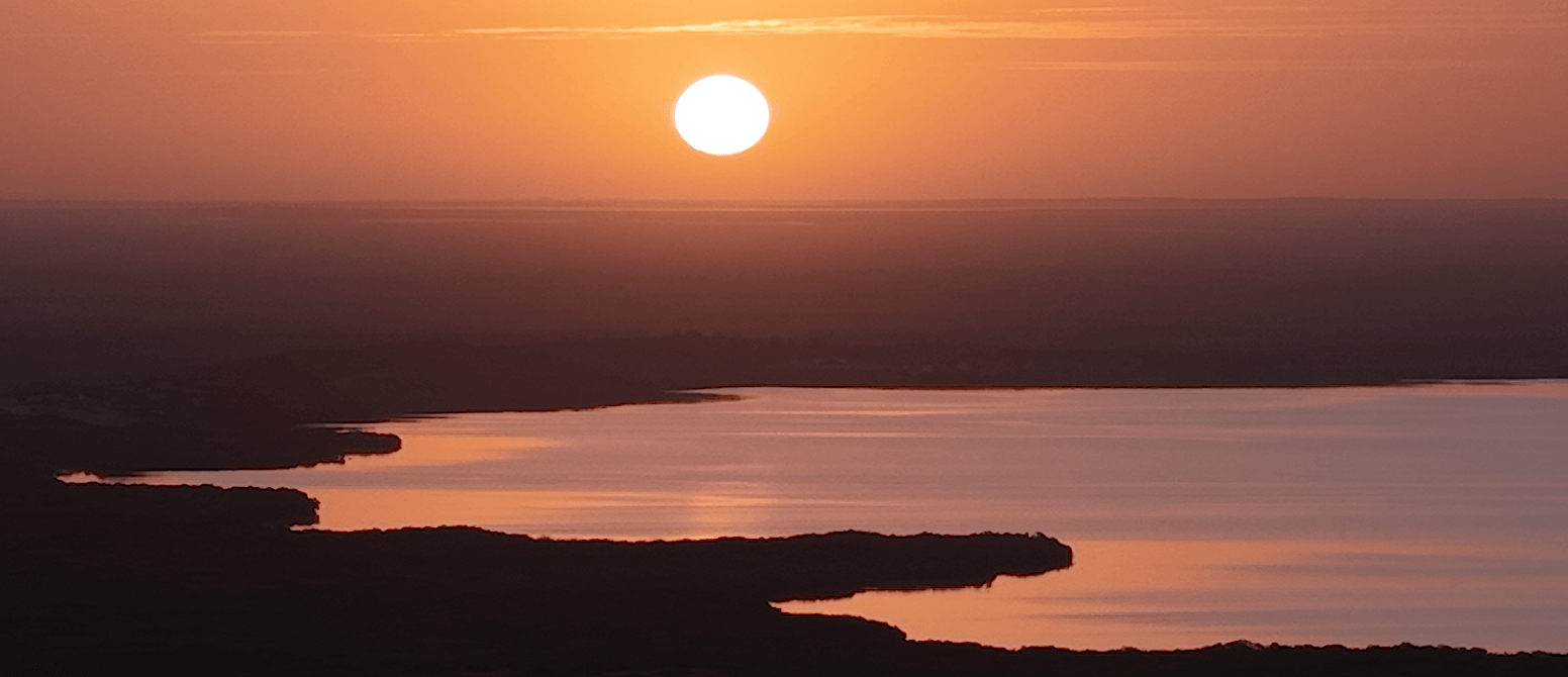 Sunset over the desert filmed from the air